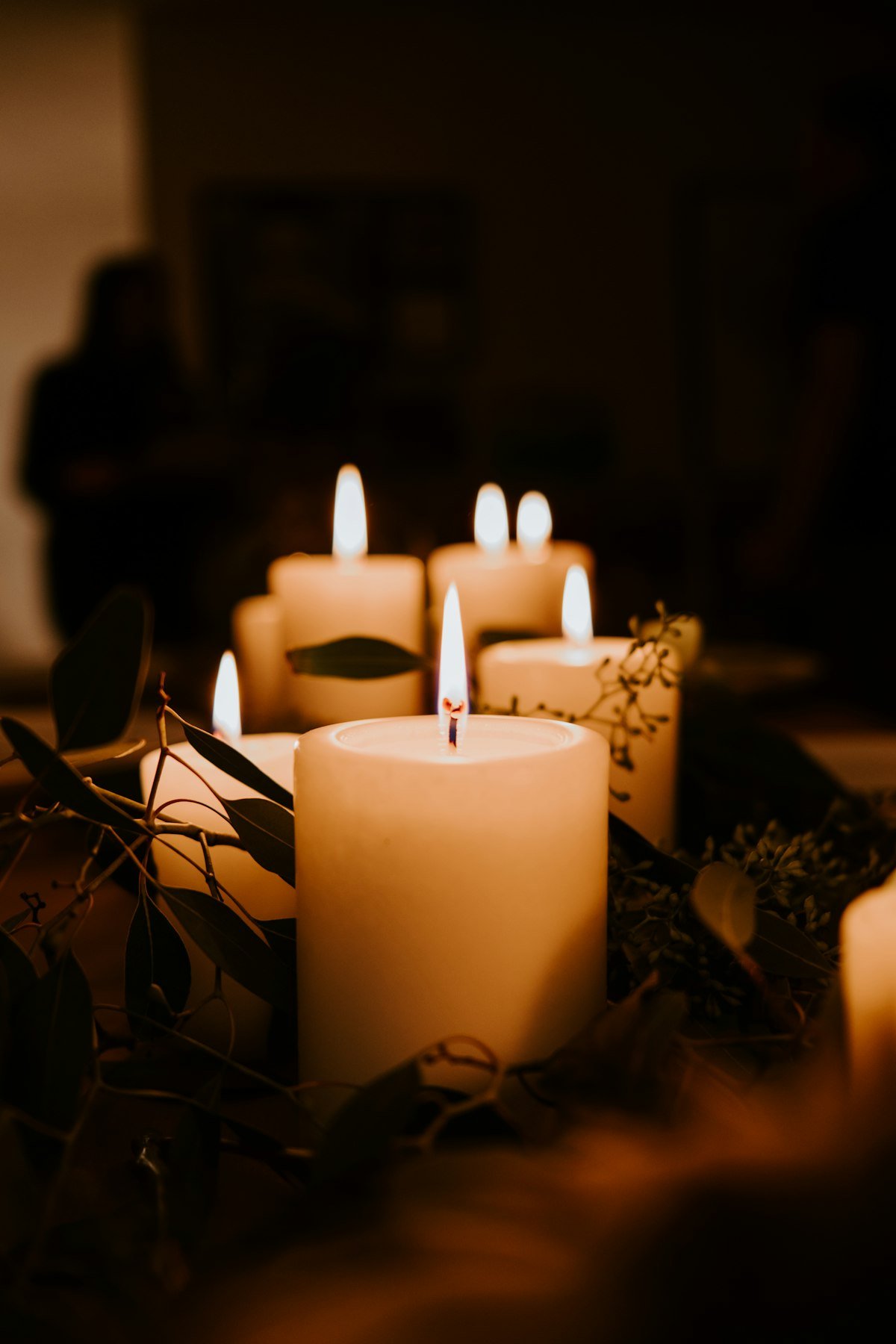 Trio of lit pillar candles glowing warmly