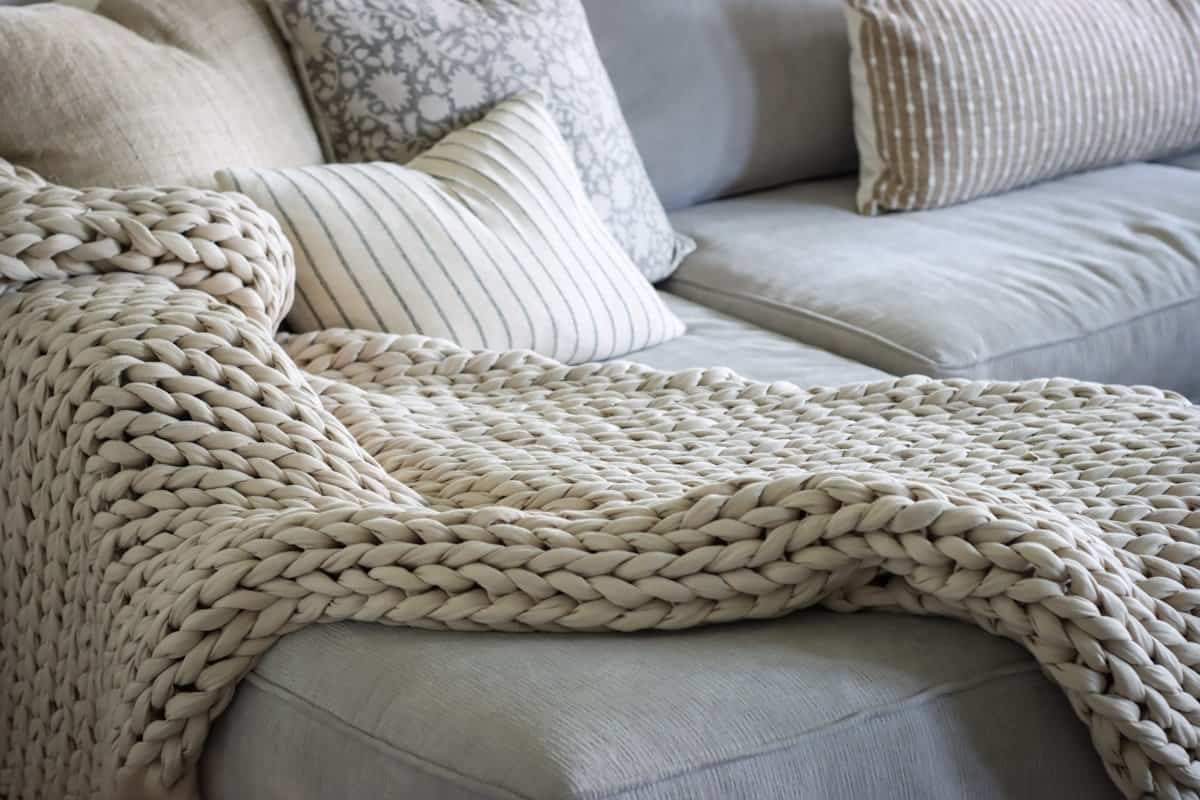 Chunky knit throw blanket draped casually for fall