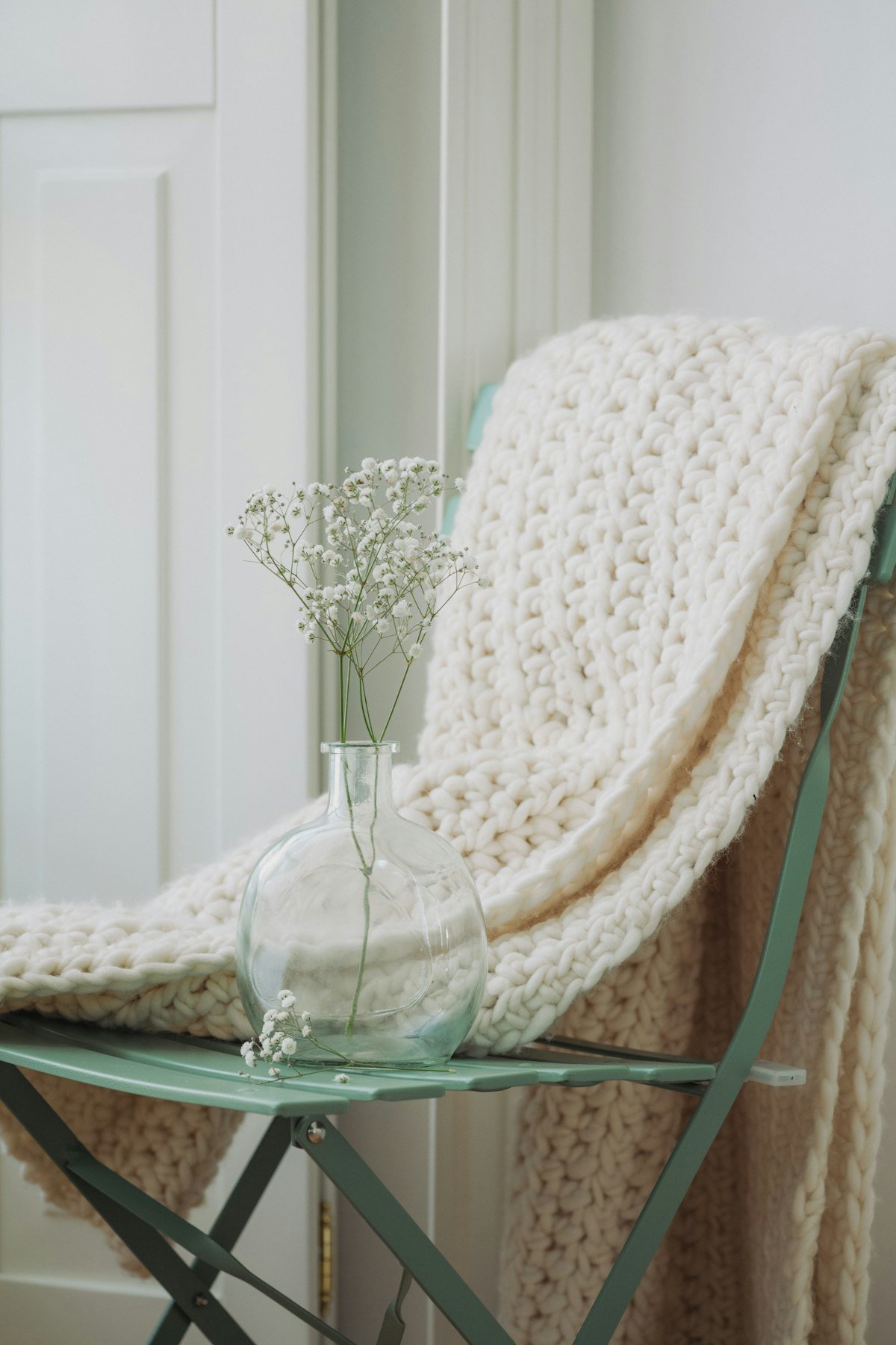 Cream chunky knit throw blanket draped softly