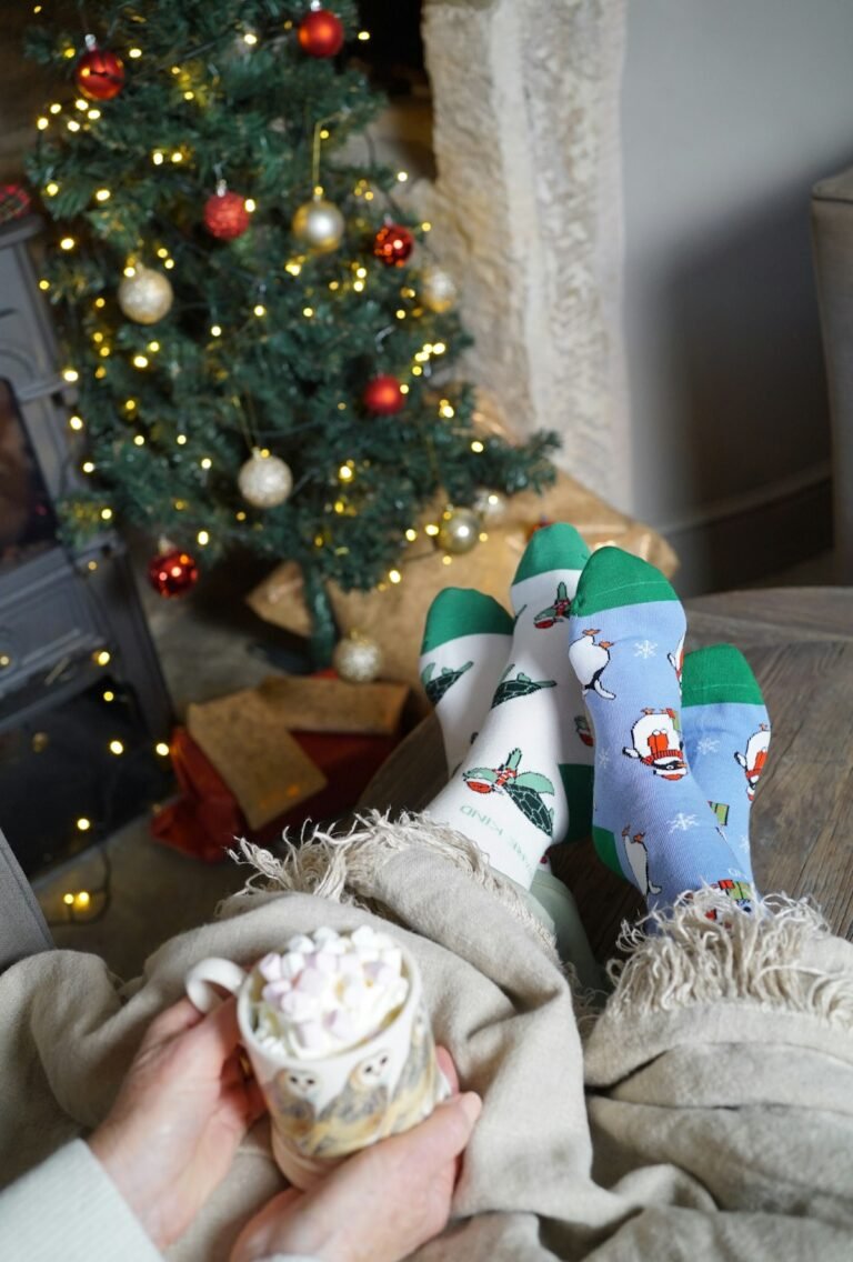 Cozy holiday socks and wrapped gifts beside a lit tree
