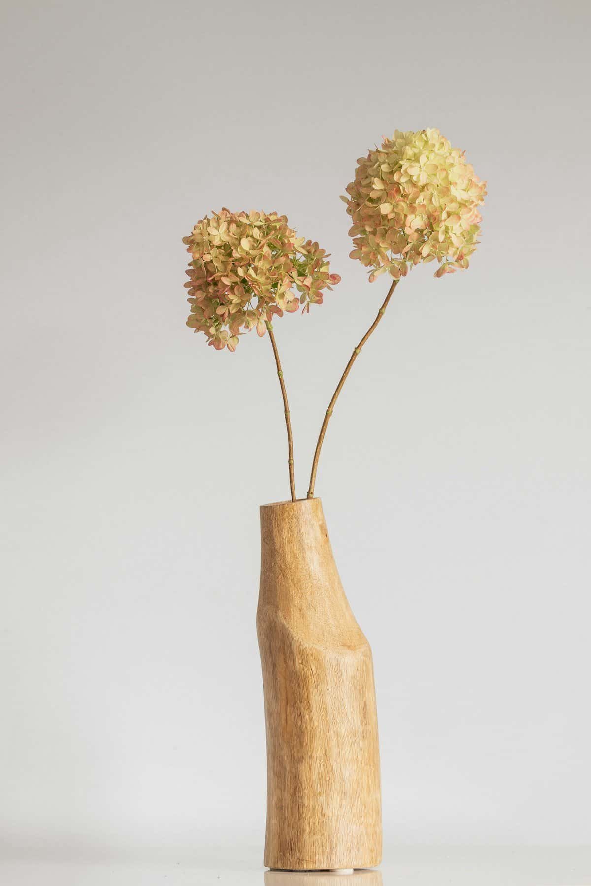 Dried fall branches arranged in a simple vase