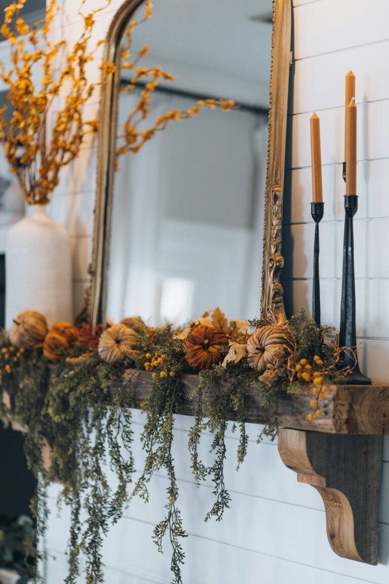 Fall mantel styled with garland and small pumpkins