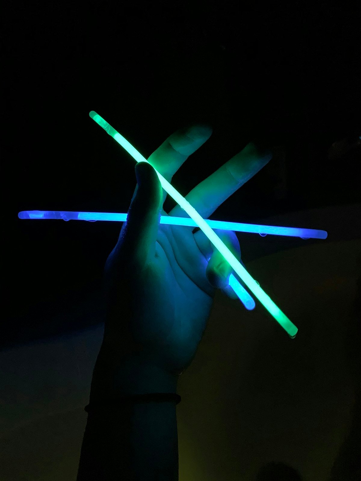 Glow sticks lighting up a dark dance party