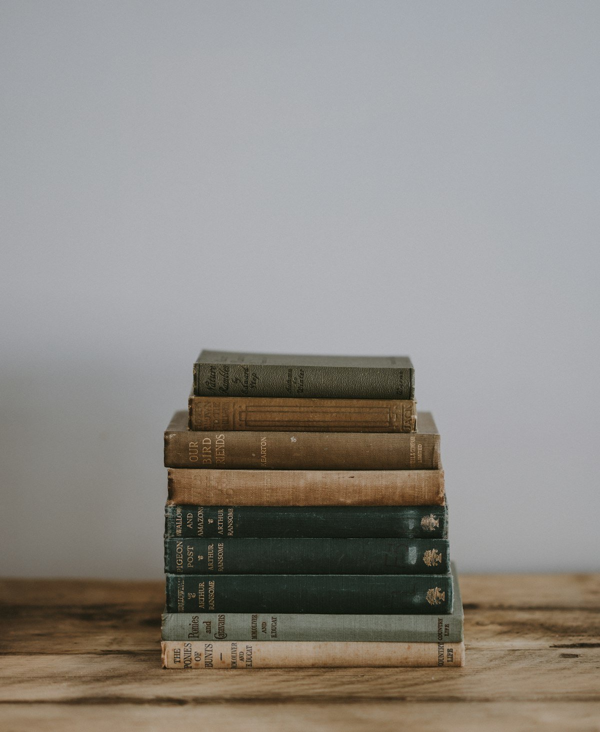 Horizontal stack of books acting as a pedestal for styling