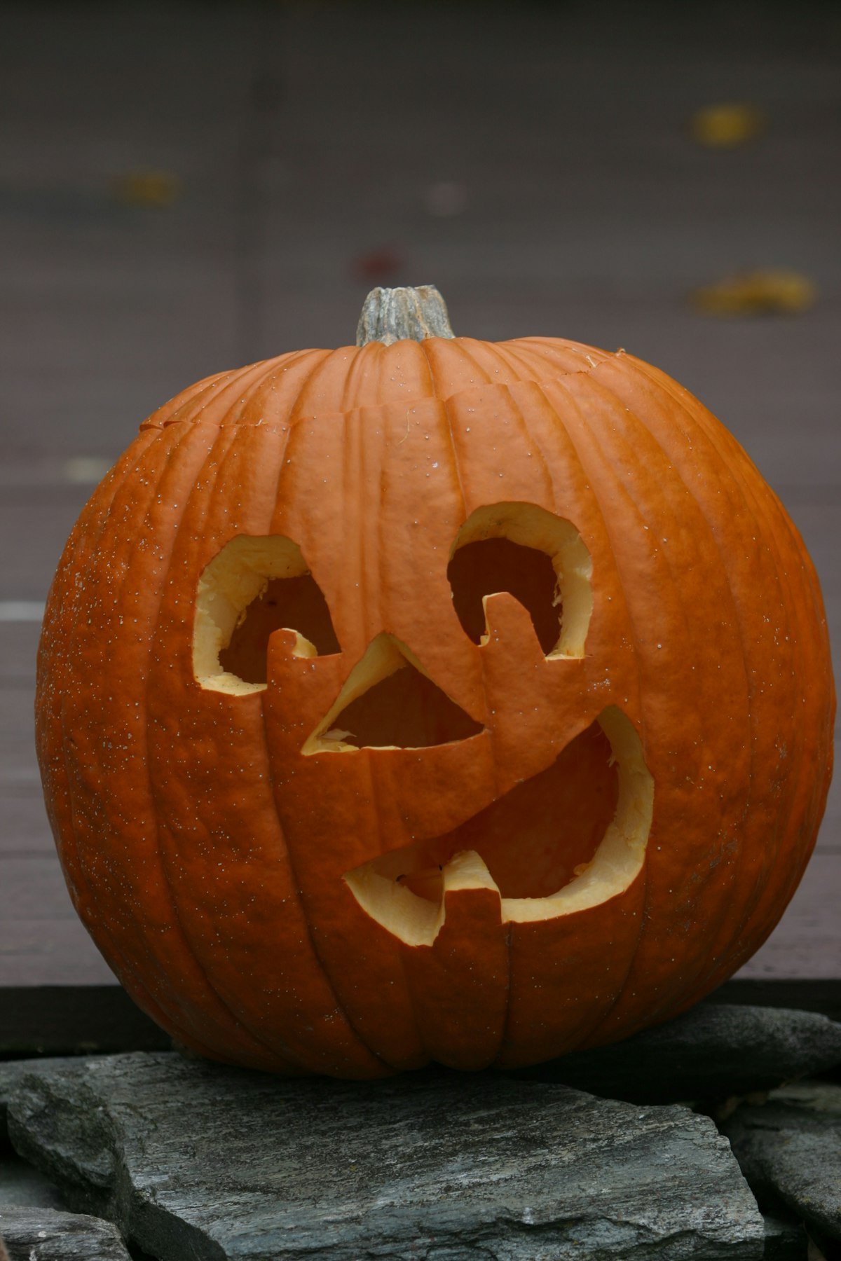 Smiling carved jack-o-lantern for a porch display