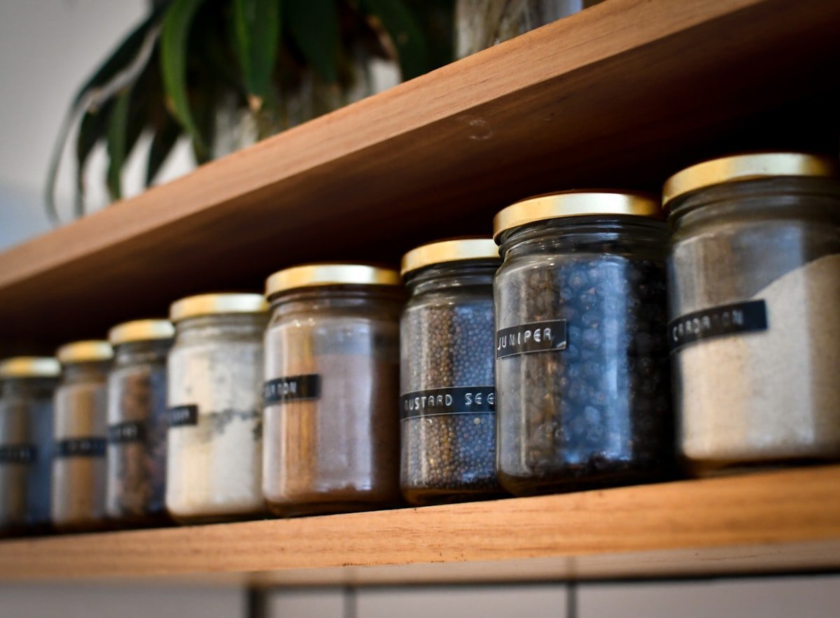 Matching labeled glass canisters lined up in a row