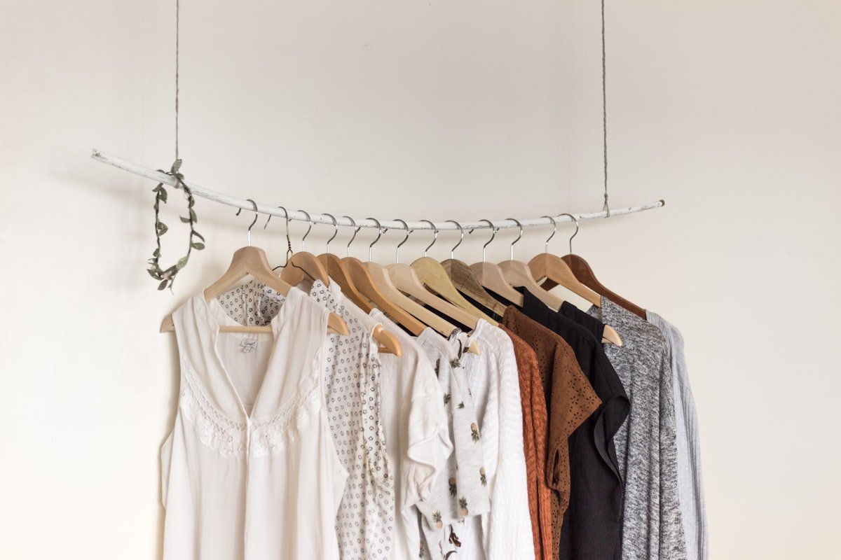 Matching slim hangers lined up on a closet rod