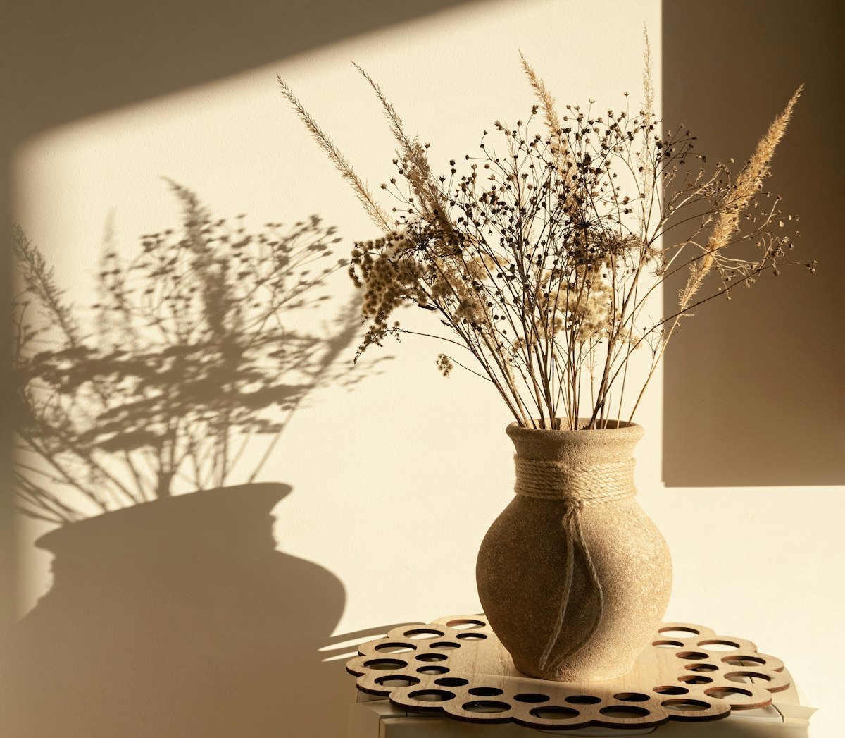 Warm terracotta toned dried flowers and vase