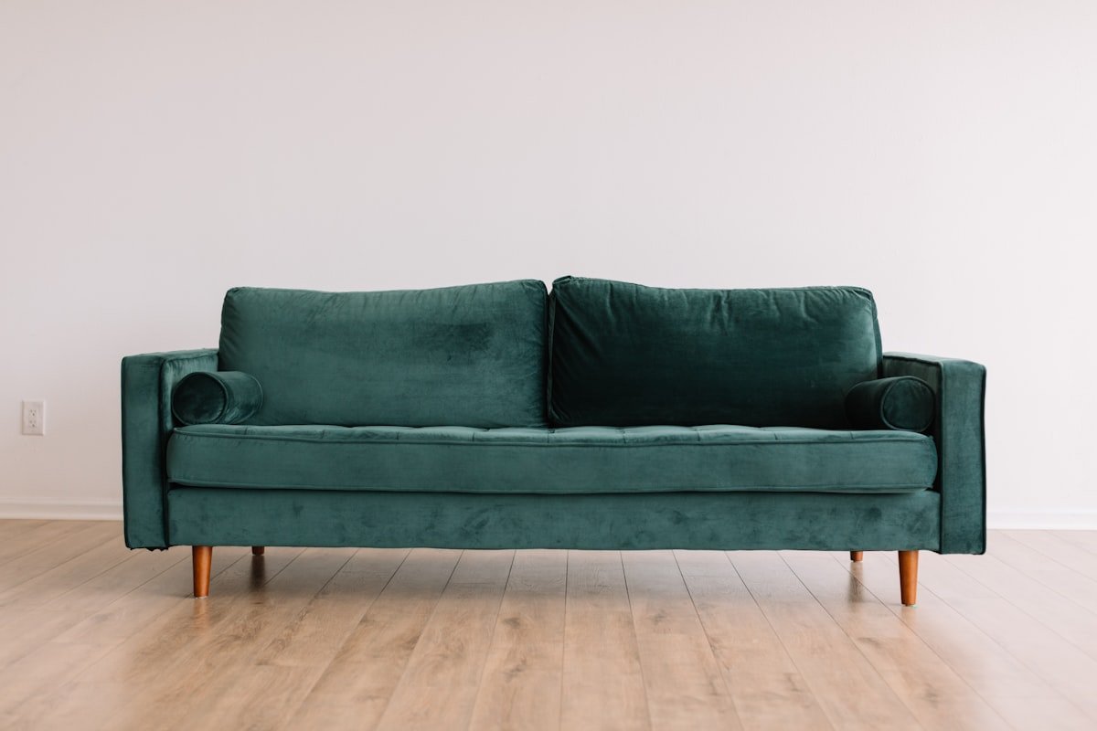 Sofa raised on slim wooden legs showing the floor beneath