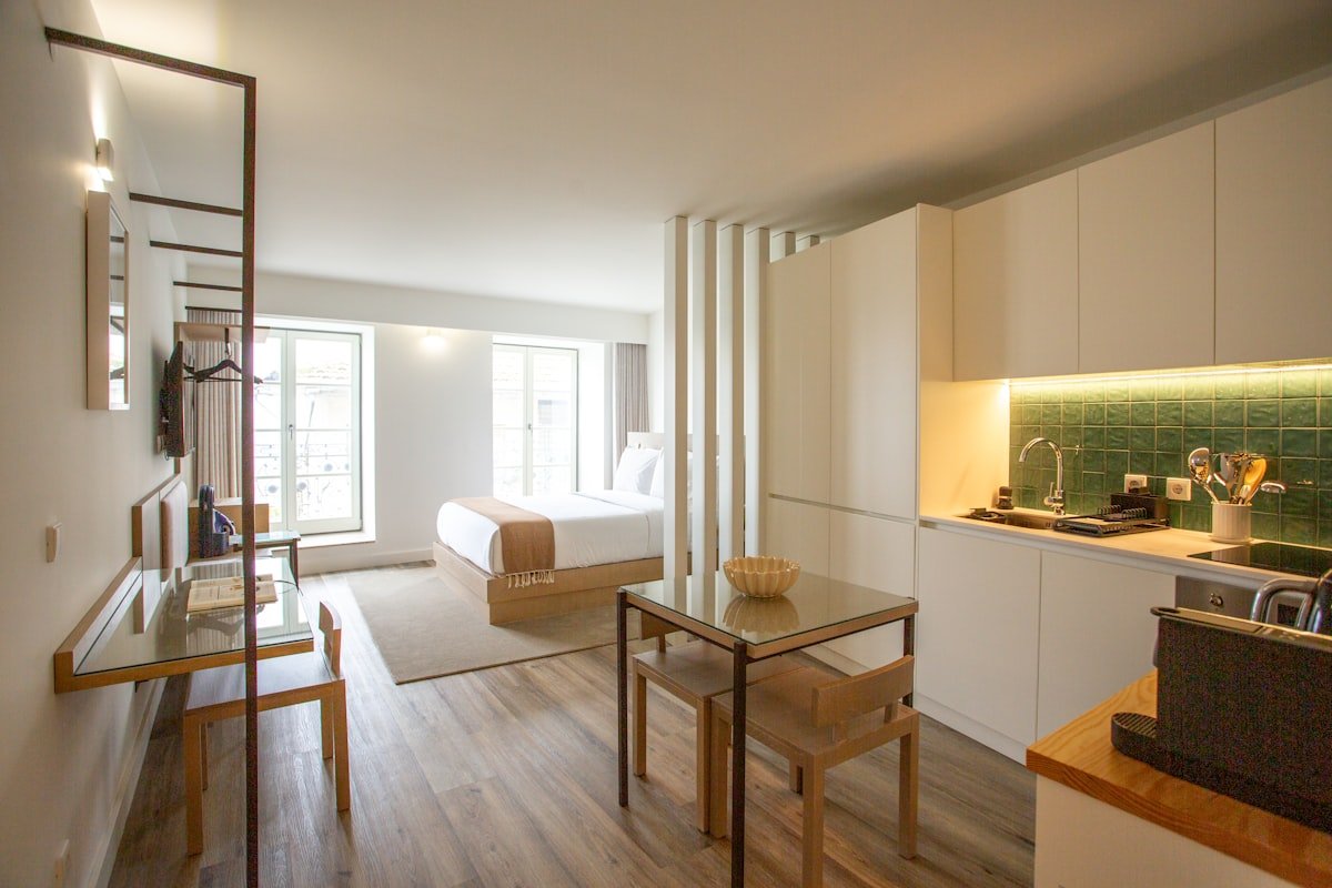 Studio apartment zoned into rooms with an open divider