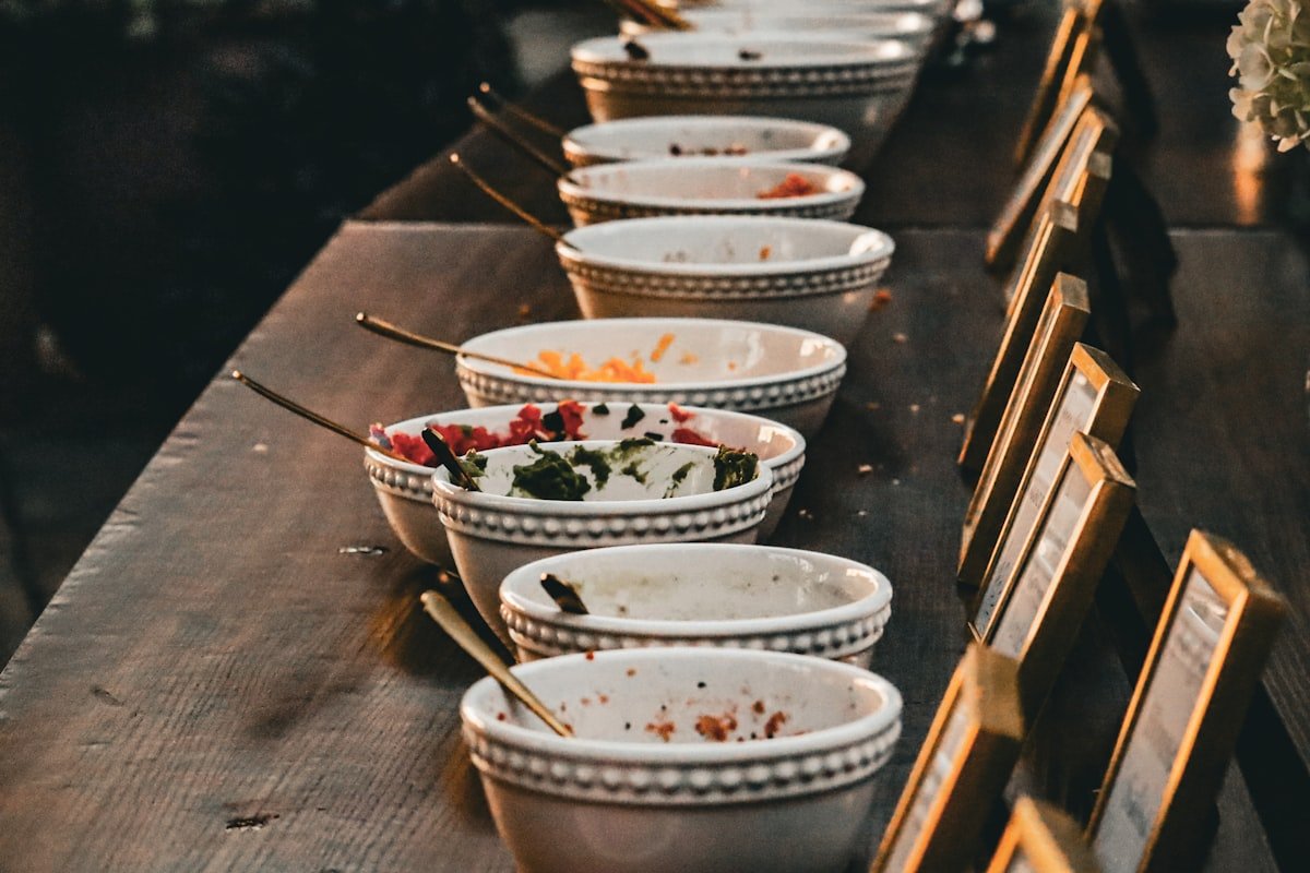 Labeled bowls of toppings at a build-your-own taco bar