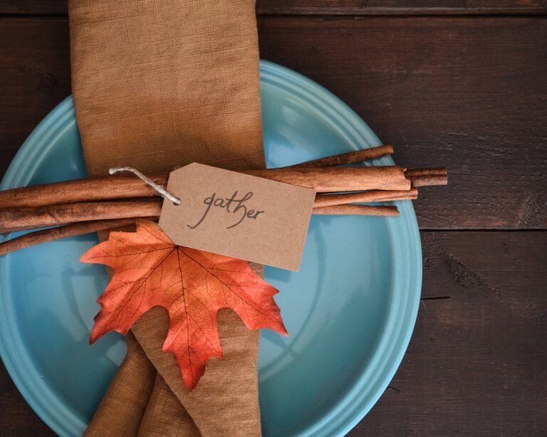 Thanksgiving place setting with autumn leaf, cinnamon sticks, and a gather tag