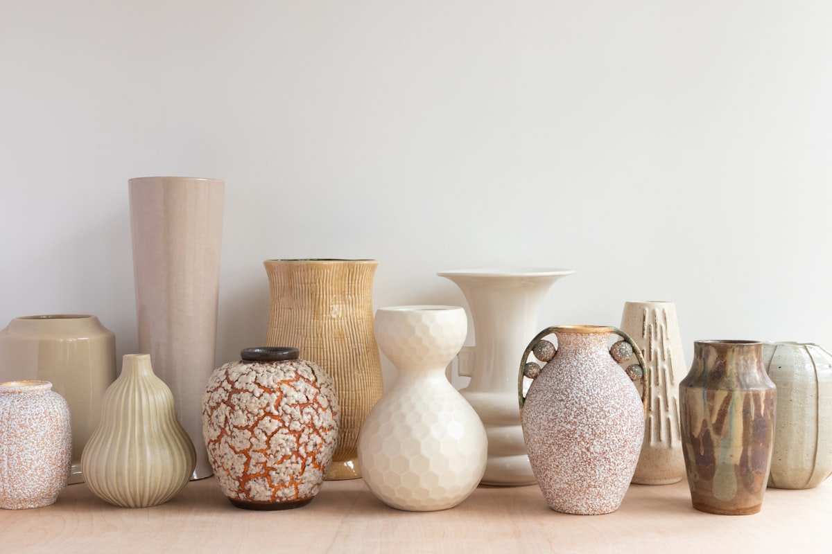 Collection of thrifted ceramic and wooden vases