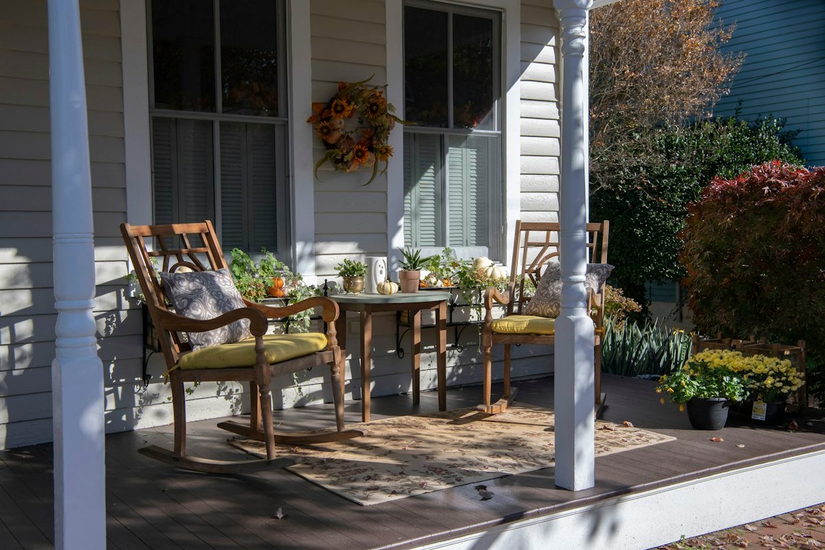Porch corner filled with mums and fall plants